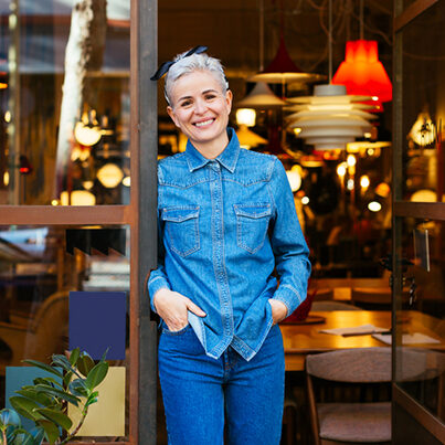 Portrait of a female entrepreneur in front of her vintage furniture store.